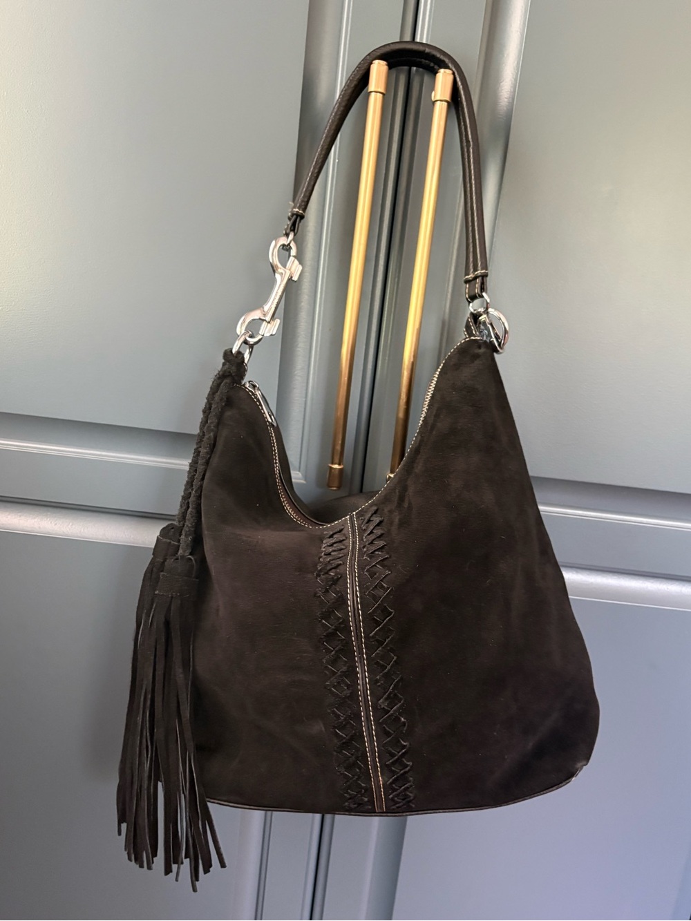 black suede Coco + Carmen hobo bag whipstitching and fringe tassels